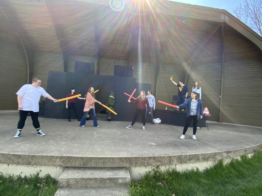 students holding pool noodles